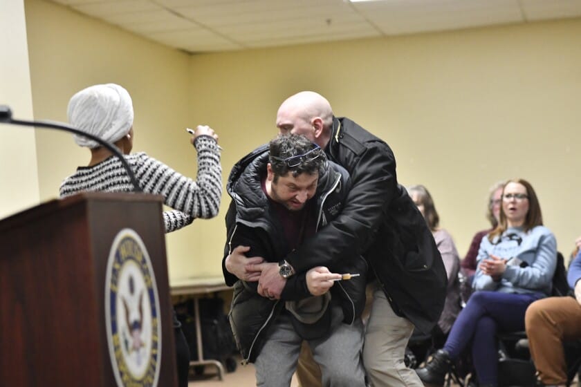 **Headline:** Man sprays unidentified substance on Rep. Ilhan Omar during Minneapolis town hall