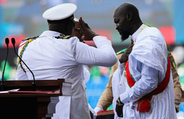 Guinea president keeps mines minister in post-election government