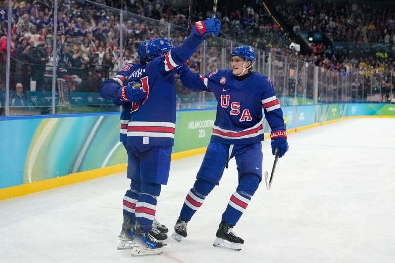 US men’s hockey team celebrating overtime victory to reach Olympic semifinals