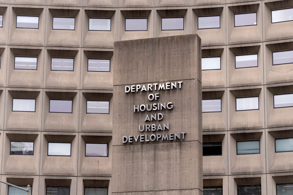 HUD building with signage about public housing and noncitizen eligibility regulation