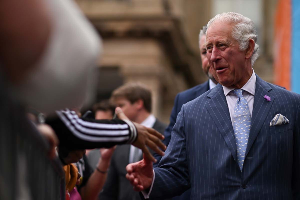 **Headline:** King Charles Interrupted by Heckler Asking About Former Prince Andrew Allegations